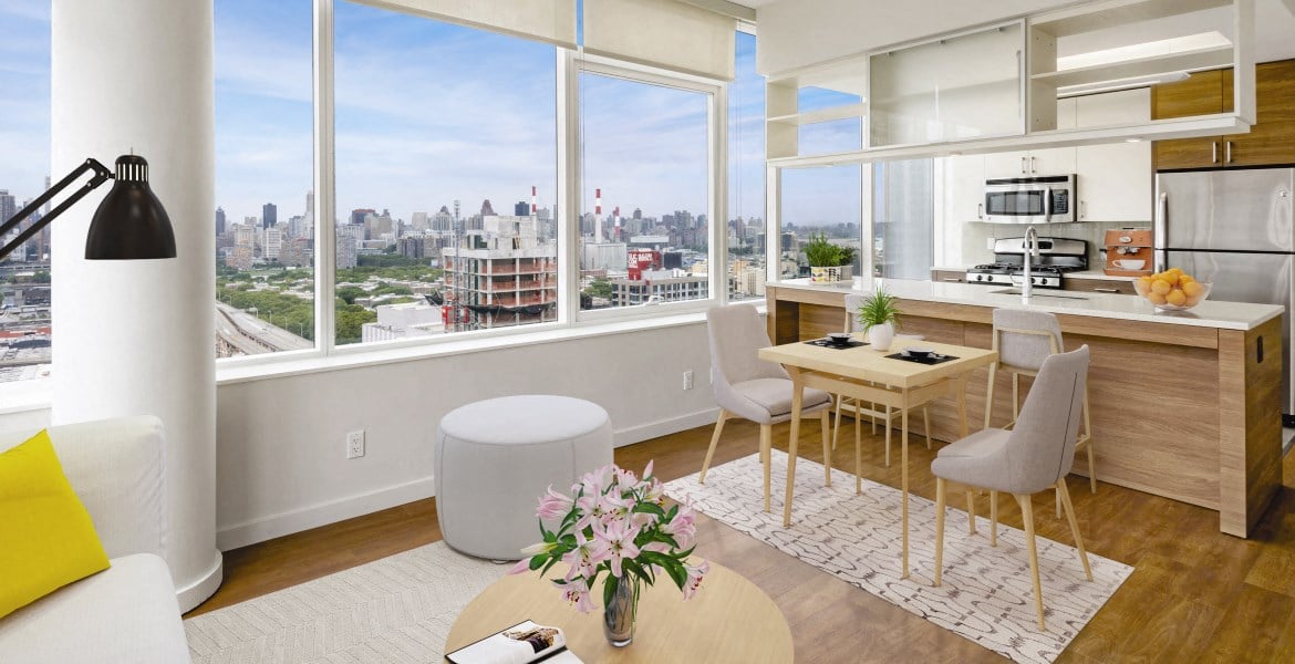 a living room with a table and chairs and a window